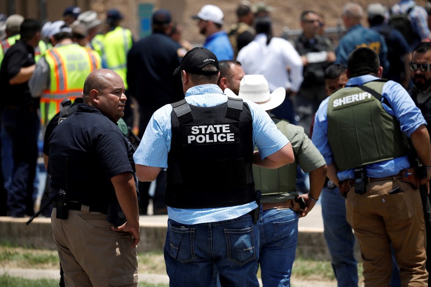 Law enforcement personnel guard the scene of a suspected shooting near Robb Elementary School in Uvalde, Texas, U.S. May 24, 2022.  REUTERS/Marco Bello