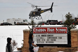 An Ohio State highway patrol helicopter leaves the grounds of Chardon High School as students leave the area in Chardon, Ohio February 27, 2012. A student opened fire with a handgun in the cafeteria of an Ohio high school east of Cleveland on Monday, fatally wounding one student and shooting four others before he was chased from the building by a teacher and gave himself up, authorities said REUTERS/Ron Kuntz  (UNITED STATES - Tags: CRIME LAW) ohio eeuu  tiroteo en el colegio chardon high school tiroteo en una escuela secundaria alumno del colegio ataco a tiros a sus compañeros