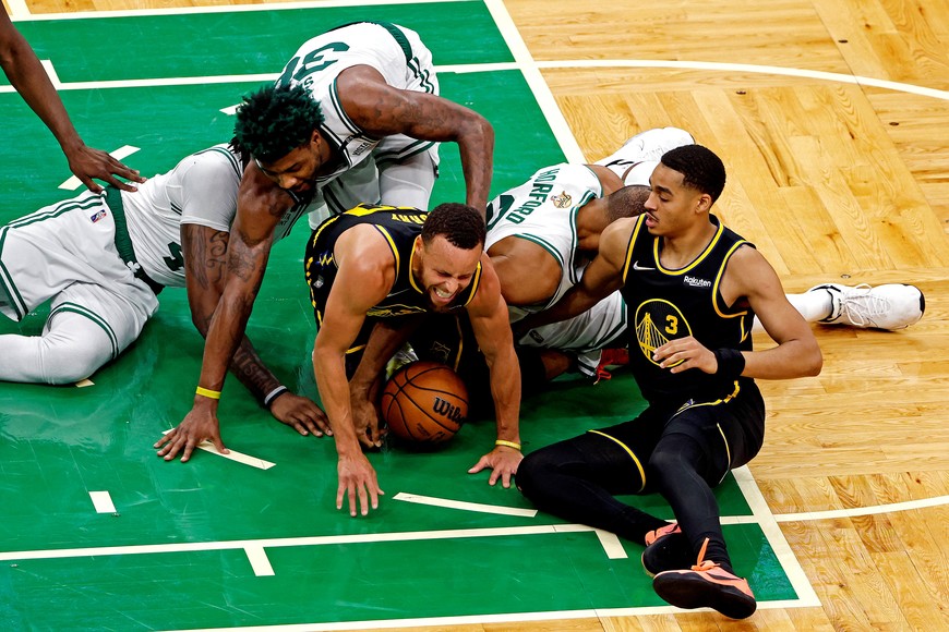 Jun 8, 2022; Boston, Massachusetts, USA; Golden State Warriors guard Stephen Curry (30) and guard Jordan Poole (3) go for the ball against Boston Celtics center Al Horford (42), guard Marcus Smart (36) and center Robert Williams III (44) during the fourth quarter in game three of the 2022 NBA Finals at TD Garden. Mandatory Credit: Winslow Townson-USA TODAY Sports