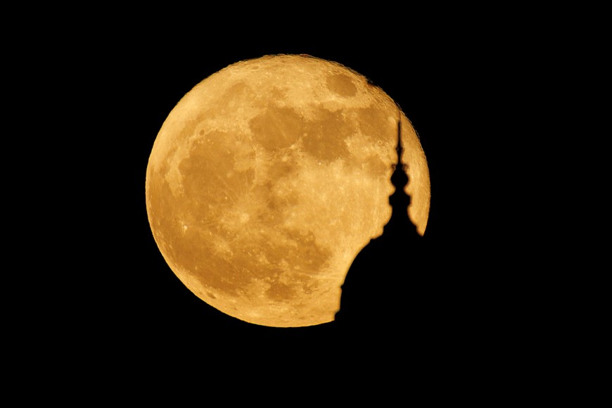 A full strawberry super moon rises behind the California Tower, constructed for the 1915 Panama-California Exposition, at Balboa Park in San Diego, California , U.S., June 14, 2022.    REUTERS/Mike Blake