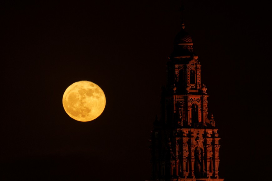 A full strawberry super moon rises behind the California Tower, constructed for the 1915 Panama-California Exposition, at Balboa Park in San Diego, California , U.S., June 14, 2022.    REUTERS/Mike Blake