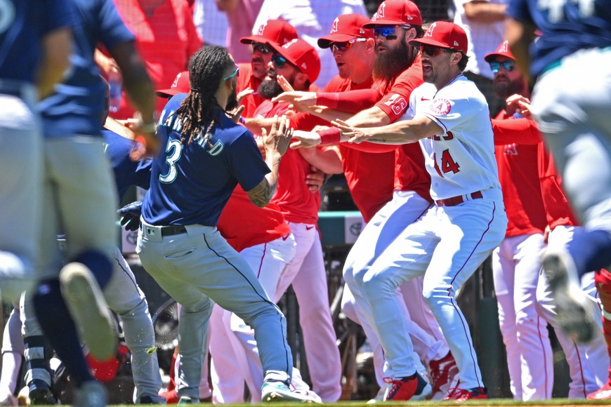 Jun 26, 2022; Anaheim, California, USA;  Los Angeles Angels players hold back Seattle Mariners shortstop J.P. Crawford (3) during a benches clearing brawl in the second inning at Angel Stadium. Mandatory Credit: Jayne Kamin-Oncea-USA TODAY Sports