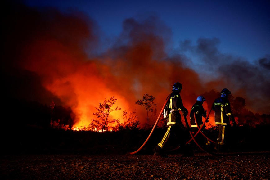 Firefighters work to contain a tactical fire in Louchats, as wildfires continue to spread in the Gironde region of southwestern France, July 17, 2022. REUTERS/Sarah Meyssonnier