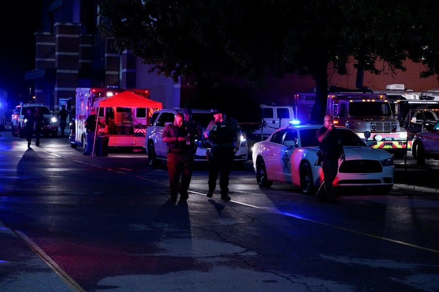 Law enforcement officers walk near the crime scene after a shooting at a mall in the Indianapolis suburb of Greenwood, Indiana, U.S. July 17, 2022. REUTERS/Cheney Orr