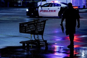 A crime scene tape is seen tied to a shopping cart after a shooting at a mall in the Indianapolis suburb of Greenwood, Indiana, U.S. July 17, 2022. REUTERS/Cheney Orr   REFILE - QUALITY REPEAT