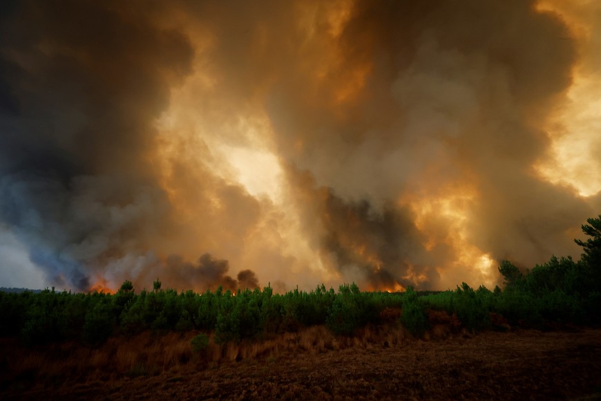 General view of smoke and flames from the fire in Belin-Beliet, as wildfires continue to spread in the Gironde region of southwestern France, August 10, 2022. REUTERS/Stephane Mahe
