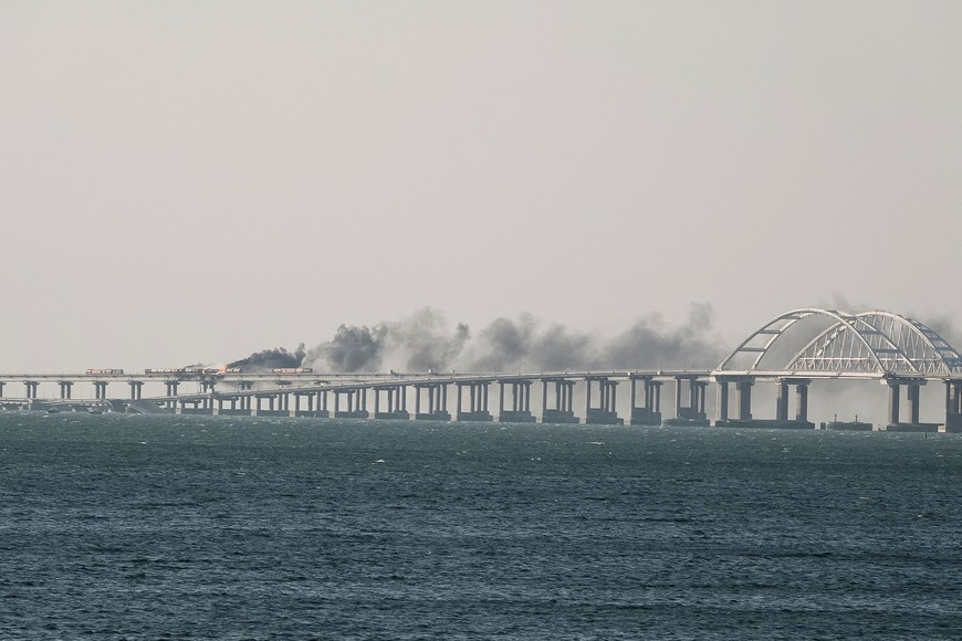 A view shows fuel tanks ablaze and damaged sections of the Kerch bridge in the Kerch Strait, Crimea, October 8, 2022.  REUTERS/Stringer