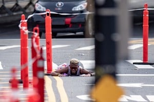 Nov 6, 2022; New York, NY, USA; David Do Nascimento of Brazil collapses after holding a big lead during the 2022 TCS New York City Marathon in New York, NY. Mandatory Credit: John Jones-USA TODAY Sports