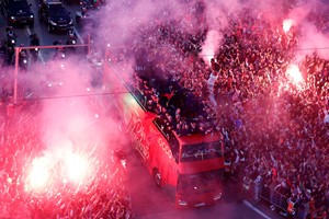 Soccer Football - FIFA World Cup Qatar 2022 - Morocco return after the World Cup - Rabat, Morocco - December 20, 2022
Fans celebrate with flares as Morocco players arrive on a bus REUTERS/Juan Medina     TPX IMAGES OF THE DAY