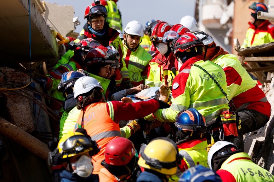 Rescuers carry a woman named Zeynep, as the search for survivors continues, in the aftermath of a deadly earthquake in Kirikhan, Turkey February 10, 2023. REUTERS/Piroschka van de Wouw