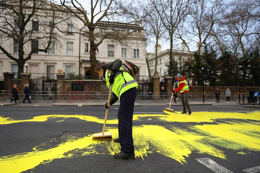 Protest group 'Led by Donkeys' spread yellow paint for the Ukrainian flag on a road, ahead of the first anniversary of Russia's invasion of Ukraine, outside the Russian Embassy in London, Britain February 23, 2023. REUTERS/Hannah McKay