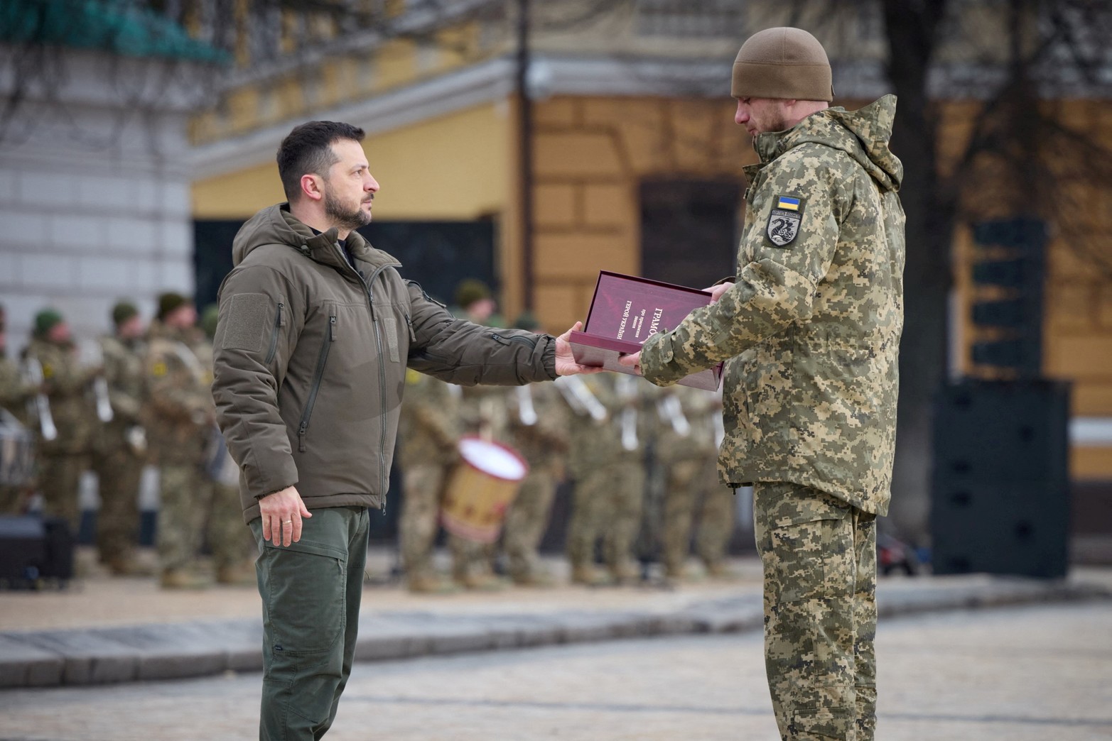 El presidente de Ucrania, Volodymyr Zelenskiy, entrega una bandera a un militar durante una ceremonia dedicada al primer aniversario de la invasión rusa de Ucrania, en medio del ataque de Rusia a Ucrania, en Kiev.