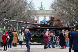 The remains of a destroyed Russian T-72 tank, secured from the Ukrainian village of Dmytrivka, outside Kyiv are on display near the the Brandenburg Gate during an event to mark the one-year anniversary of the Russian invasion of Ukraine, in Berlin, Germany, February 24, 2023. REUTERS/Fabrizio Bensch