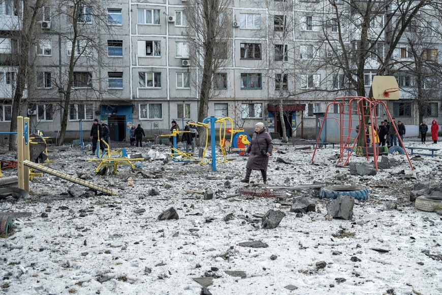 A woman walks on a playground after an apartment block was heavily damaged by a missile strike, amid Russia's attack on Ukraine, in Pokrovsk, Donetsk region, Ukraine, February 15, 2023. REUTERS/Marko Djurica