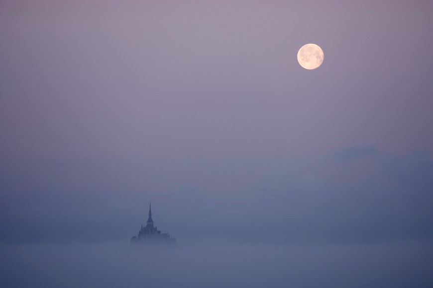 The moon sets above the iconic Mont Saint-Michel in Vains, in the French western region of Normandy, France, April 7, 2023. REUTERS/Stephane Mahe     TPX IMAGES OF THE DAY