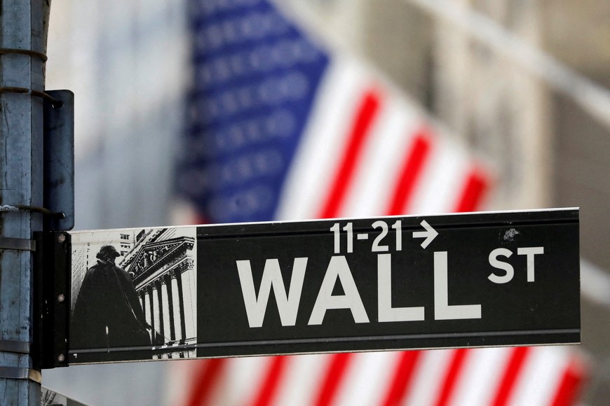 FILE PHOTO: A street sign for Wall Street is seen outside the New York Stock Exchange (NYSE) in New York City, New York, U.S., July 19, 2021. REUTERS/Andrew Kelly//File Photo