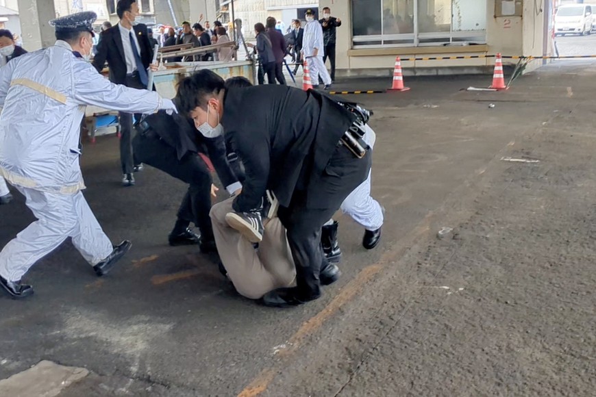 Law enforcement personnel hold a person to ground after an explosion was heard near Japanese Prime Minister Fumio Kishida's outdoor speech, in Saikazaki, Wakayama Prefecture, Japan, April 15, 2023 in this screen grab obtained from a social media video. Twitter @Ak2364N/via REUTERS  THIS IMAGE HAS BEEN SUPPLIED BY A THIRD PARTY. MANDATORY CREDIT. NO RESALES. NO ARCHIVES.