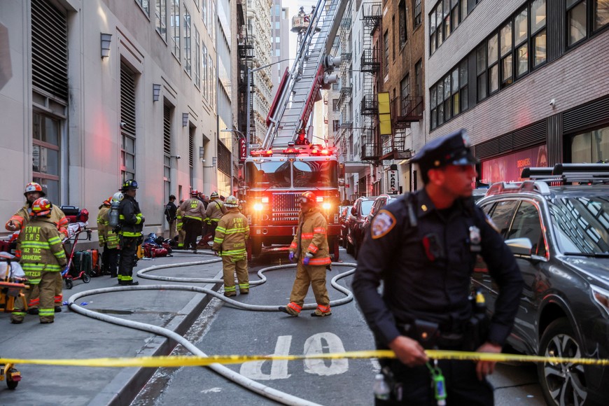 Firefighters work at the site of a collapsed parking garage in the Manhattan borough of New York City, U.S., April 18, 2023.  REUTERS/Brendan McDermid