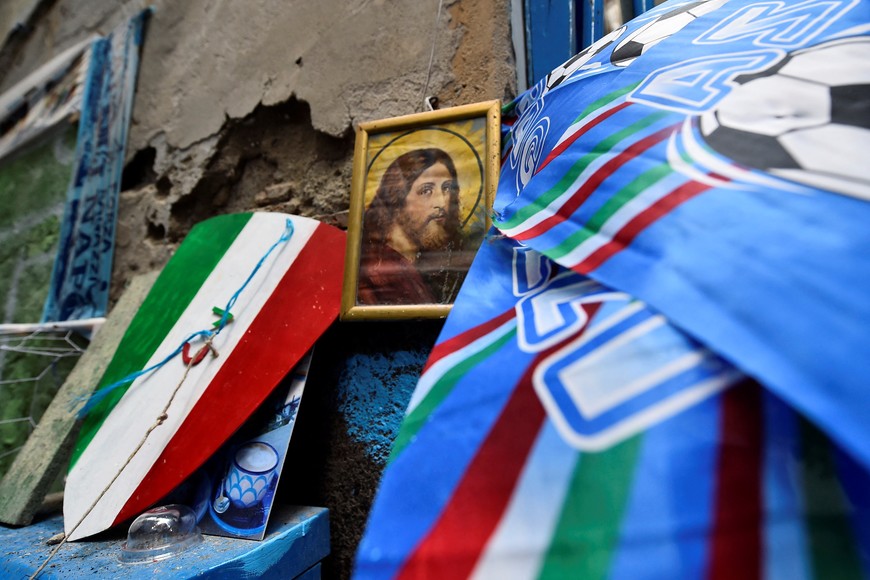 Soccer Football - Previews ahead of Napoli v Salernitana where Napoli can potentially win Serie A - Naples, Italy - April 29, 2023
Napoli decorations are seen in the street of Naples alongside a religious picture, ahead of potentially winning Serie A REUTERS/Massimo Pinca