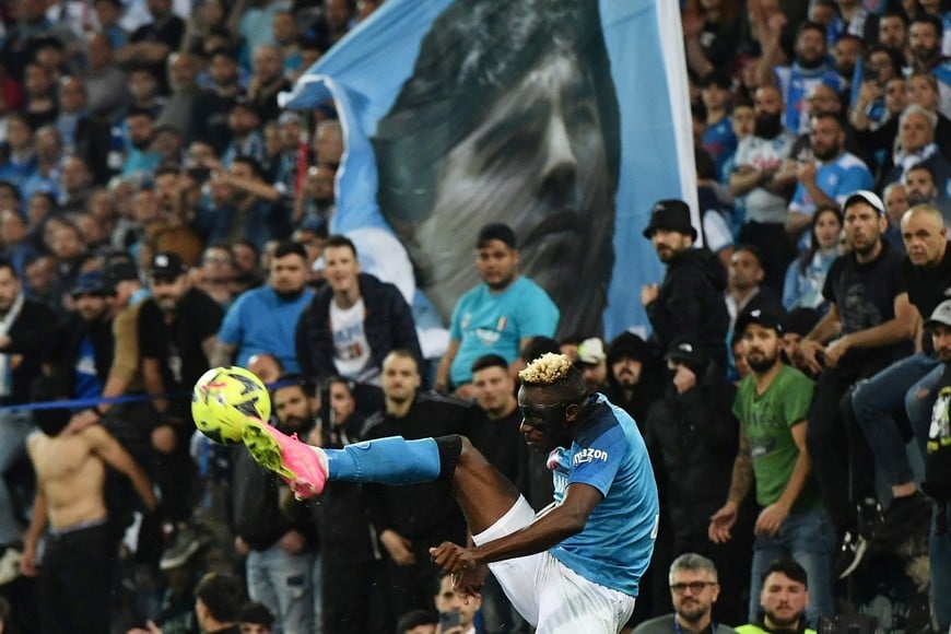 Soccer Football - Serie A - Udinese v Napoli - Dacia Arena, Udine, Italy - May 4, 2023
Napoli's Victor Osimhen in action as Napoli fans watch with a Diego Maradona flag REUTERS/Jennifer Lorenzini