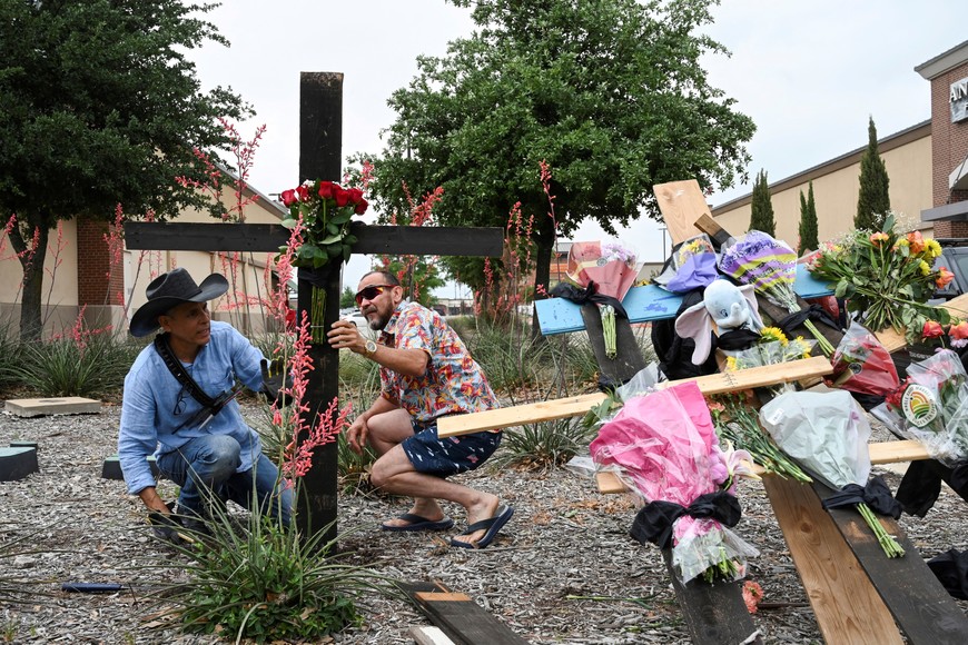 Muralist Roberto Marquez and his friend Israel Gil from Dallas erect a memorial to honor those who lost their lives when a gunman shot multiple people at the Dallas-area Allen Premium Outlets mall in Allen, Texas, U.S.  Robert says, ‘This is like a refuge for the people who lost loved ones, a place where they can come and express all their emotions”. He believes that the memorial is a priority for the difficult situation, people need a place to gather. May 7, 2023. REUTERS/Jeremy Lock