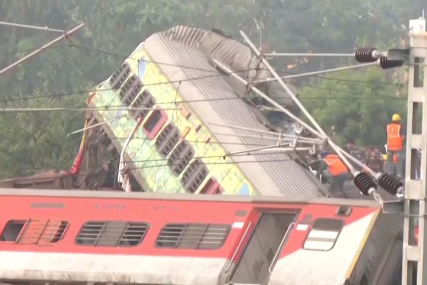 Rescue workers work atop mangled train carriages, following a deadly collision of two trains, in Balasore, India June 3, 2023, in this still image obtained from a video. ANI/Reuters TV via REUTERS THIS IMAGE HAS BEEN SUPPLIED BY A THIRD PARTY. NO RESALES. NO ARCHIVES INDIA OUT. NO COMMERCIAL OR EDITORIAL SALES IN INDIA