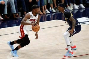 Jun 4, 2023; Denver, CO, USA; Miami Heat forward Jimmy Butler (22) controls the ball against Denver Nuggets guard Kentavious Caldwell-Pope (5) in the fourth quarter in game two of the 2023 NBA Finals at Ball Arena. Mandatory Credit: Isaiah J. Downing-USA TODAY Sports