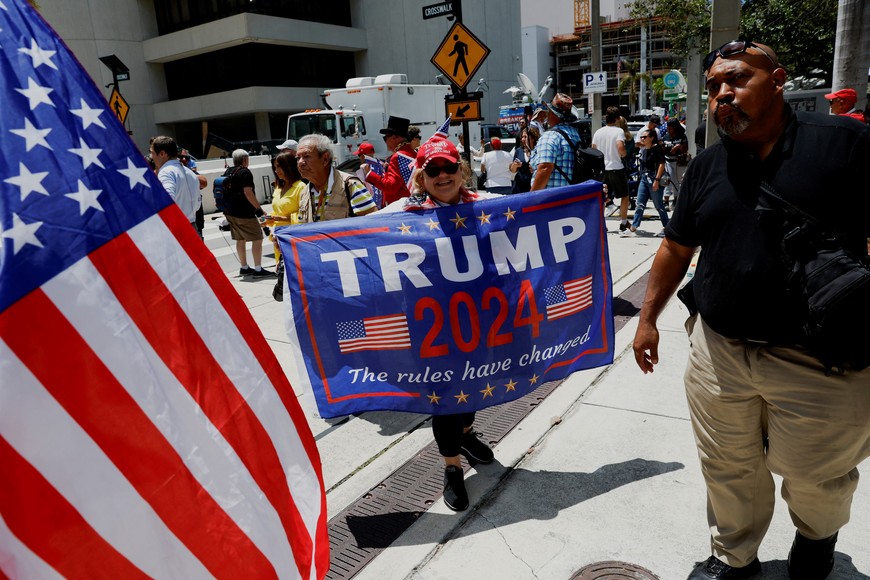 A person holds a banner near the Wilkie D. Ferguson Jr. United States Courthouse, on the day former U.S. President Donald Trump is to appear at his arraignment on classified document charges, in Miami, Florida, U.S., June 13, 2023. REUTERS/Marco Bello