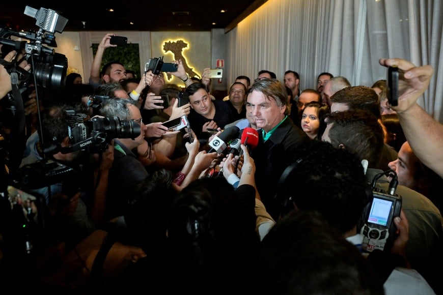 Brazil's former President Jair Bolsonaro talks with media at a restaurant, on the day the Electoral Justice continues the trial to determine his political rights, in Belo Horizonte, Brazil June 30, 2023. REUTERS/Washington Alves