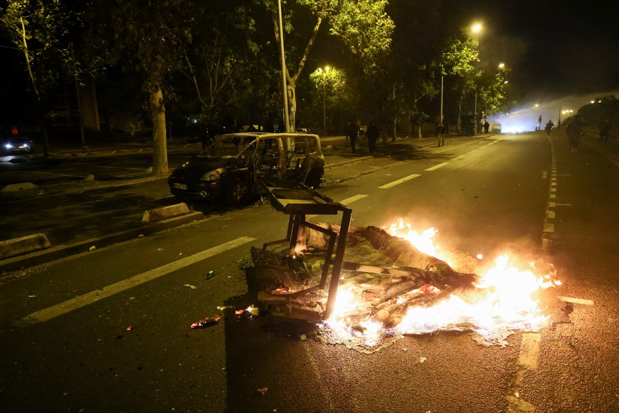 A burning barricade is seen as unrest continues following the death of a 17-year-old teenager killed by a French police officer during a traffic stop, in Nanterre, Paris suburb, France, July 1, 2023. REUTERS/Yves Herman