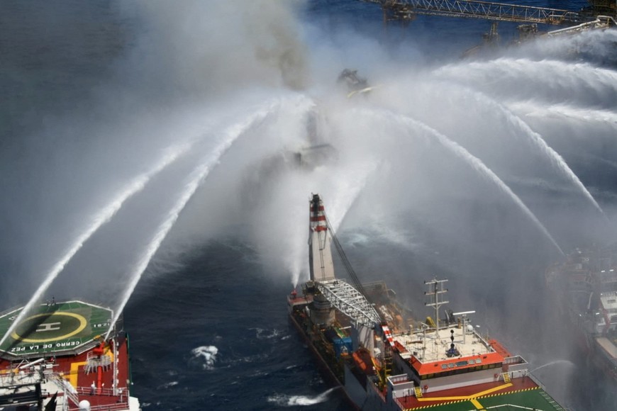 Boats spray water onto an offshore oil platform that caught fire at the Pemex's Cantarell Field, in the Bay of Campeche, Mexico July 7, 2023. Courtesy Petroleos Mexicanos (PEMEX) @Pemex/Handout via REUTERS ATTENTION EDITORS - THIS IMAGE WAS PROVIDED BY A THIRD PARTY. NO RESALES. NO ARCHIVES. MANDATORY CREDIT