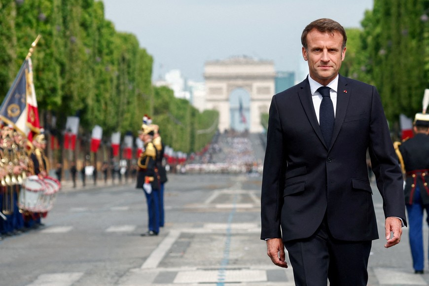France's President Emmanuel Macron walks on the day of the annual Bastille Day military parade on the Champs-Elysees avenue in Paris, France, July 14, 2023. REUTERS/Gonzalo Fuentes/Pool     TPX IMAGES OF THE DAY