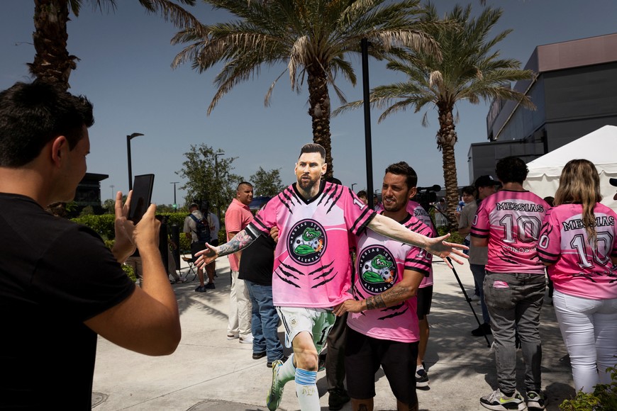 A supporter poses for a photo with a cardboard cut-out of Argentinian soccer player Leo Messi during a gathering outside the Inter Miami DRV Pnk Stadium, in Fort Lauderdale, Florida, U.S., July 11, 2023. REUTERS/Marco Bello