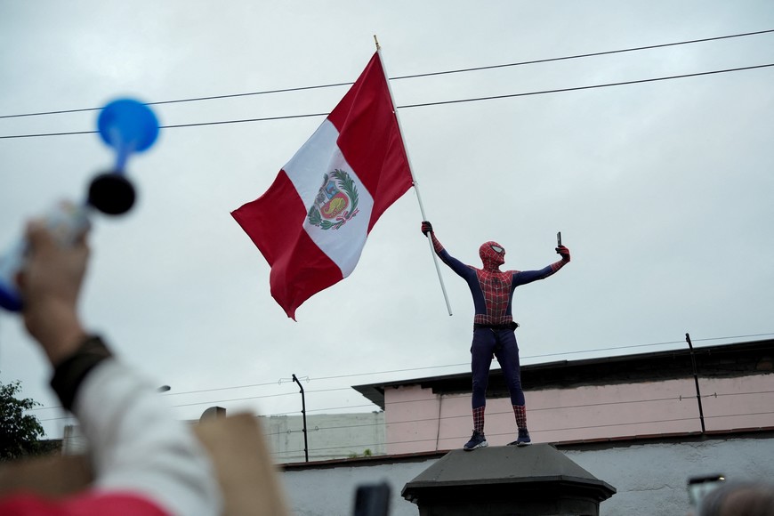 A person in a costume of the character Spider-Man holds a flag as anti-government demonstrators protest against President Dina Boluarte in Lima, Peru July 19, 2023. REUTERS/Angela Ponce