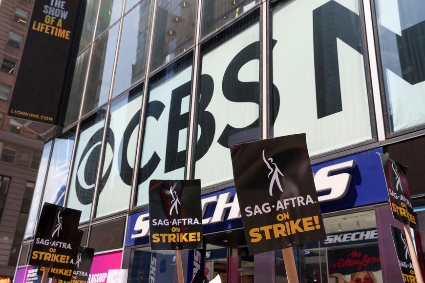 Striking Writers Guild of America (WGA) and Screen Actors Guild (SAG) members walk the picket line outside CBS studio in Times Square, during their strike in New York City, U.S., July 14, 2023. REUTERS/Brendan Mcdermid
