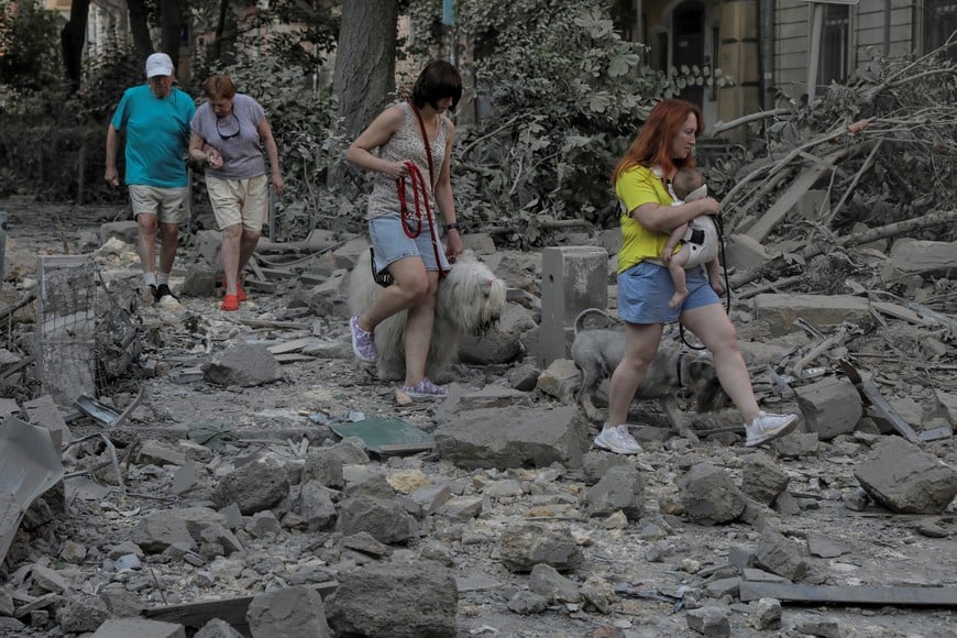 Local residents walks across debris at a site of a residential building damaged during Russian missile strikes, amid Russia's attack on Ukraine, in Odesa, Ukraine July 23, 2023. REUTERS/Nina Liashonok