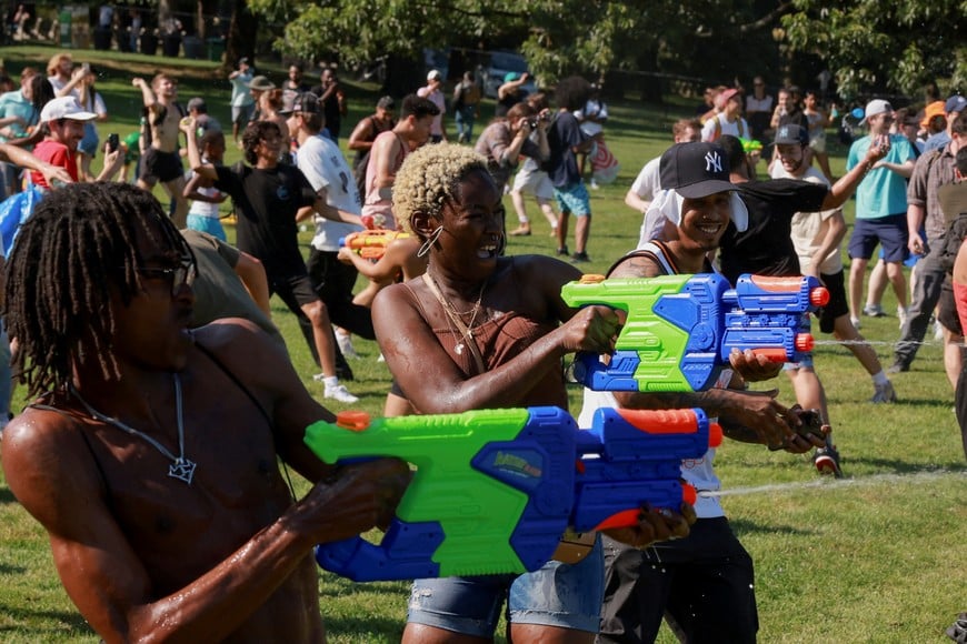 People participate in a water-balloon fight during a heat wave in Manhattan's Central Park, in New York City, U.S., July 28, 2023. REUTERS/Amr Alfiky