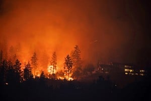 The McDougall Creek wildfire burns next to houses in the Okanagan community of West Kelowna, British Columbia, Canada, August 19, 2023. REUTERS/Chris Helgren REFILE - CORRECTING LOCATION FROM 'OUTSIDE' TO 'IN'     TPX IMAGES OF THE DAY