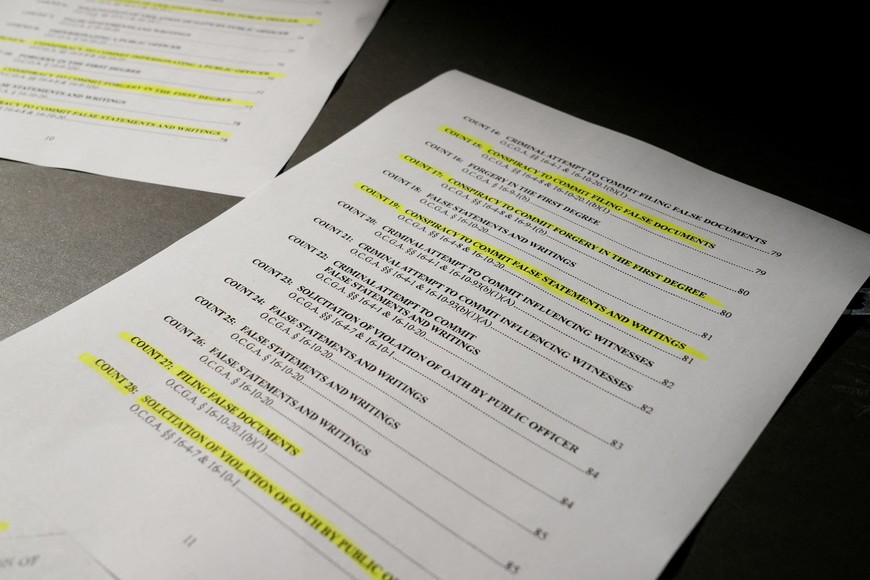 A view of the indictment, after a Georgia grand jury voted to indict former president Donald Trump with several felonies late Monday night in the case investigating attempts to overturn the results of the 2020 presidential election, is pictured at the Reuters Washington office, D.C., U.S. August 15, 2023. REUTERS/Julio-Cesar Chavez REFILE - CORRECTING DATE TO AUGUST 15, 2023.