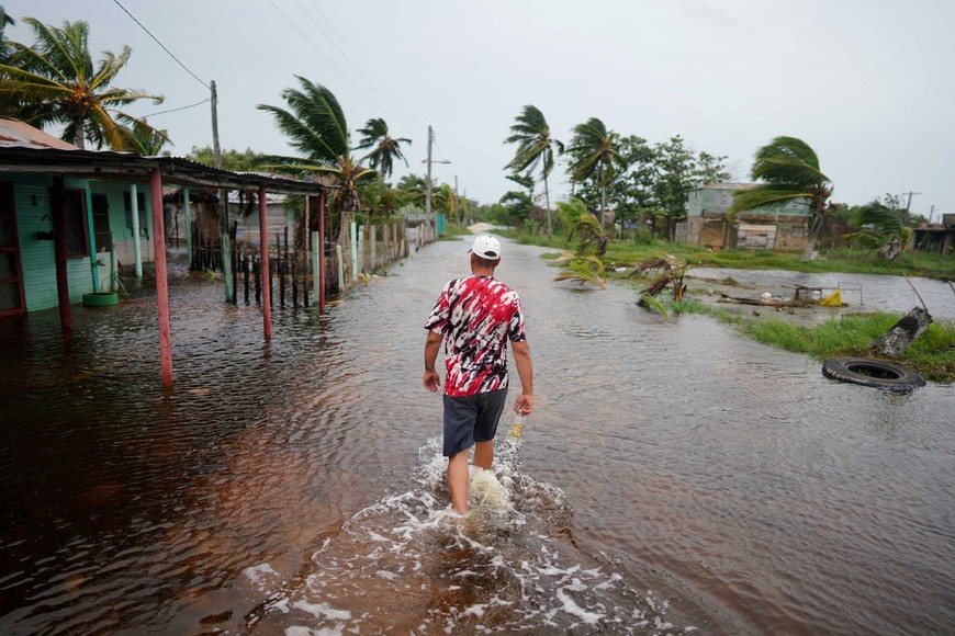 School teacher Roy Ross, 49, walks in a flooded road after the passage of Storm Idalia in Playa Majana, Cuba, August 29, 2023. REUTERS/Alexandre Meneghini