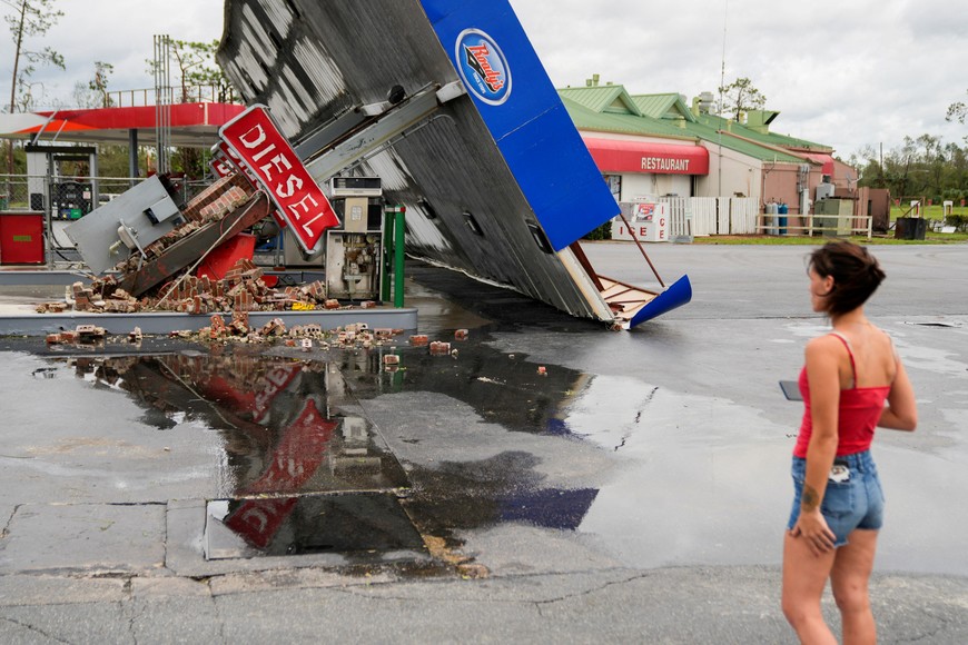Hope Laird looks at the wreckage of a gas station near her home after the arrival of Hurricane Idalia in Perry, Florida, U.S., August 30, 2023. REUTERS/Cheney Orr     TPX IMAGES OF THE DAY