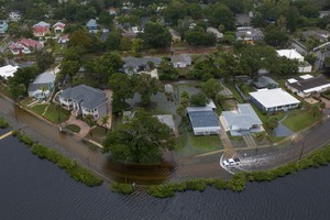 A vehicle moves through flood waters in the aftermath of Hurricane Idalia in Tarpon Springs, Florida, U.S., August 30, 2023. REUTERS/Adrees Latif     TPX IMAGES OF THE DAY