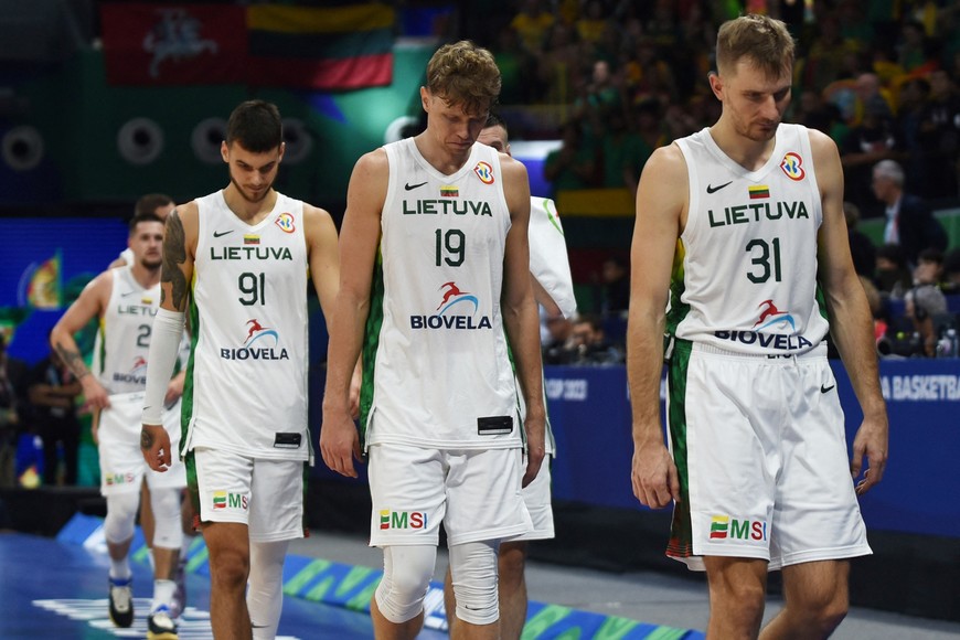 Basketball - FIBA World Cup 2023 - Quarter-Final - Lithuania v Serbia - Mall of Asia Arena, Manila, Philippines - September 5, 2023
Lithuania's Vaidas Kariniauskas, Mindaugas Kuzminskas and Deividas Sirvydis look dejected after the match REUTERS/Lisa Marie David