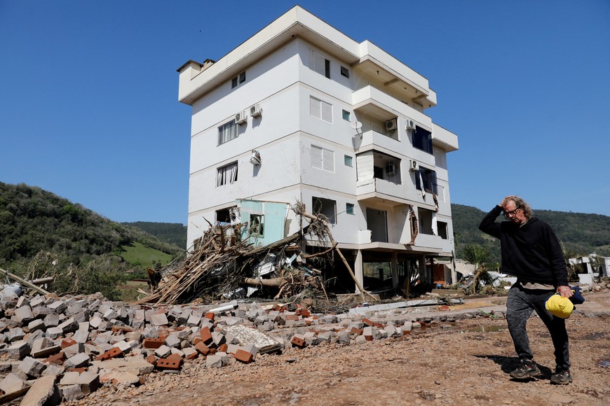 A person walking in front of a damaged building after an extratropical cyclone hit southern towns, in Mucum, Rio Grande do Sul, Brazil, September 6, 2023. REUTERS/Diego Vara     TPX IMAGES OF THE DAY