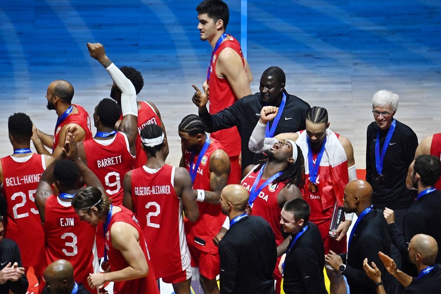 Basketball - FIBA World Cup 2023 - Third-Place Playoff - United States v Canada - Mall of Asia Arena, Manila, Philippines - September 10, 2023
Canada players celebrate with their bronze medals after the match REUTERS/Lisa Marie David