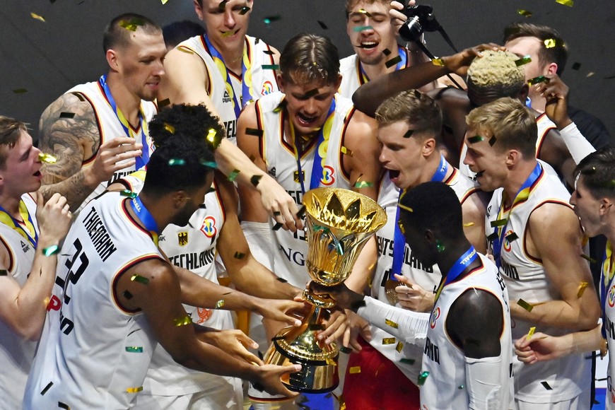 Basketball - FIBA World Cup 2023 - Final - Germany v Serbia - Mall of Asia Arena, Manila, Philippines - September 10, 2023
Germany players celebrate with the trophy after winning the FIBA World Cup 2023 Final REUTERS/Lisa Marie David