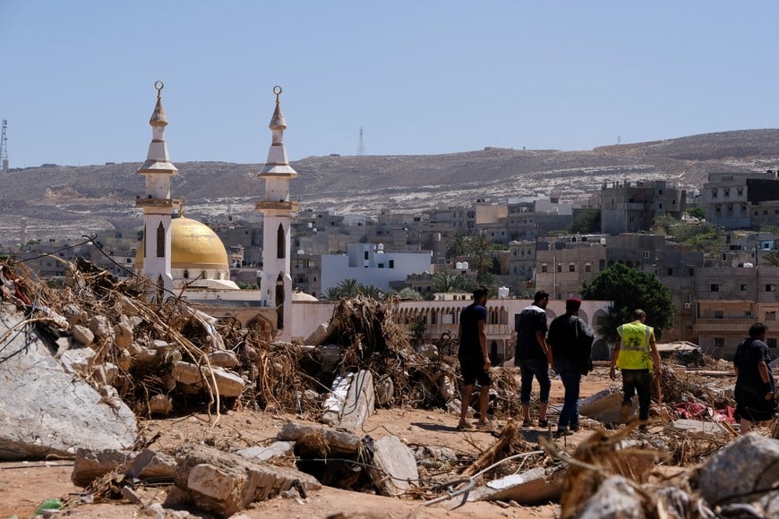 People walk between the rubbles, after a powerful storm and heavy rainfall hit Libya, in Derna, Libya September 13, 2023. REUTERS/Esam Omran Al-Fetori