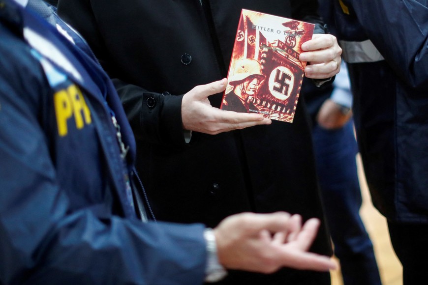 Victor Garelik, DAIA's executive director (Delegation of Argentine-Israeli Associations), holds a Nazi propaganda book, after a raid carried out by Argentina's Anti-Terrorist Investigation Unit Department, where they arrested a man leading a propaganda distribution operation, in Buenos Aires, Argentina September 13, 2023. REUTERS/Agustin Marcarian