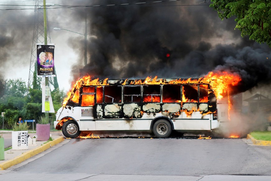A burning bus, set alight by cartel gunmen to block a road, is pictured during clashes with federal forces following the detention of Ovidio Guzman, son of drug kingpin Joaquin "El Chapo" Guzman, in Culiacan, Sinaloa state, Mexico October 17, 2019. REUTERS/Jesus Bustamante