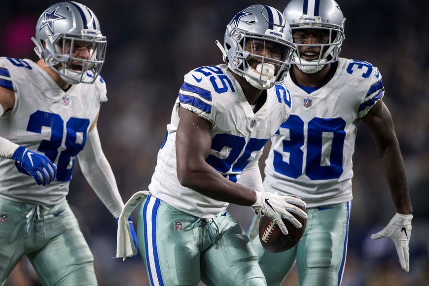 Nov 22, 2018; Arlington, TX, USA; Dallas Cowboys free safety Xavier Woods (25) and cornerback Anthony Brown (30) and strong safety Jeff Heath (38) celebrates Woods making an interception against the Washington Redskins during the second quarter at AT&T Stadium. Mandatory Credit: Jerome Miron-USA TODAY Sports